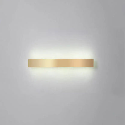 Minimalist gold plated LED wall sconce bar light by Decorbites with warm glow on wall on Tampa Home & Garden Store