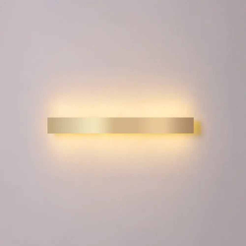 Decorbites gold plated LED wall sconce, minimalist horizontal bar with warm backlit glow on Tampa Home & Garden Store