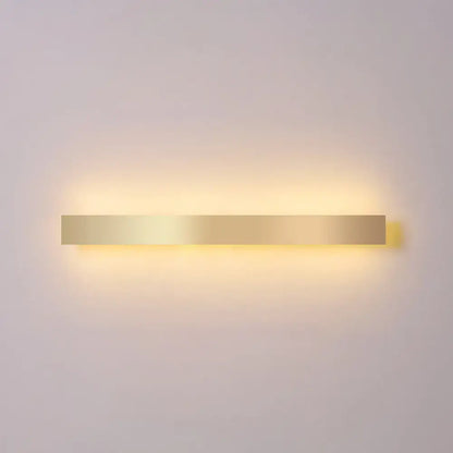 Minimalist gold plated LED wall sconce bar light with a long bar and warm glow on wall on Tampa Home & Garden Store