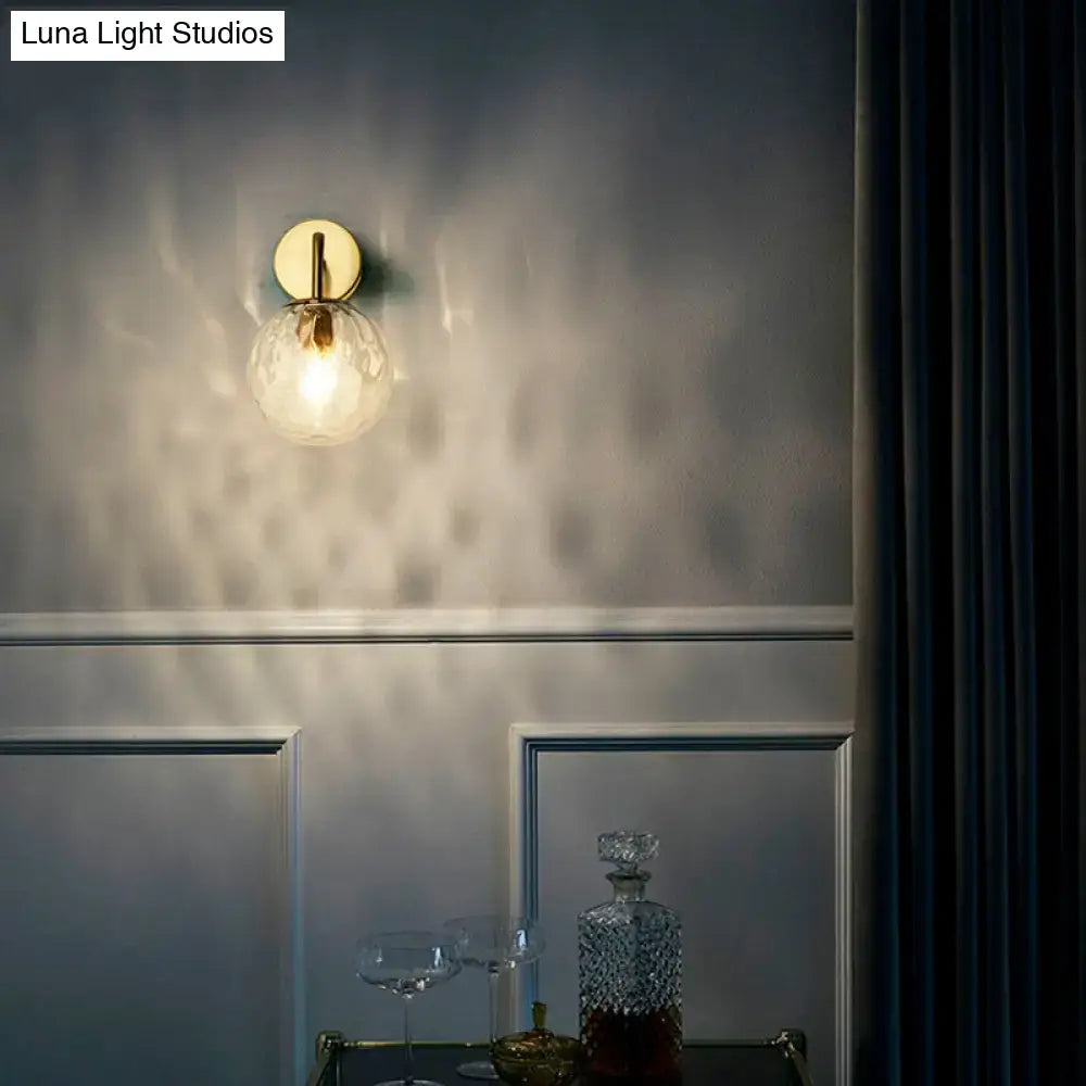 Gold Rippled Glass Lamp wall sconce Decorbites; ribbed glass globe with warm glow on gray wall on Tampa Home & Garden Store