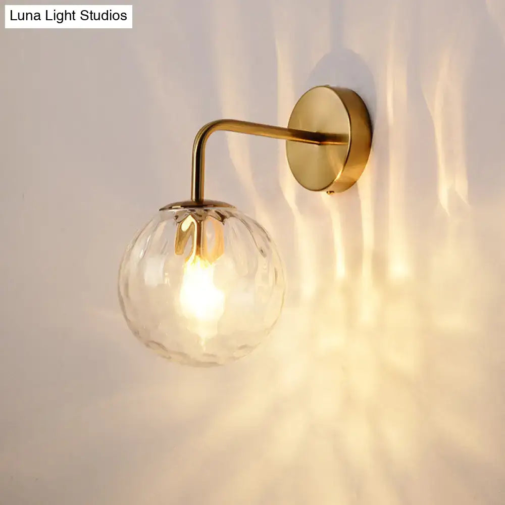 Gold Rippled Glass Lamp wall sconce with brass arm and clear ribbed globe on Tampa Home & Garden Store