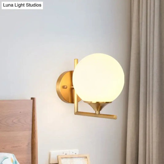 Gold sphere wall sconce by Decorbites with brass finish and frosted globe on Tampa Home & Garden Store