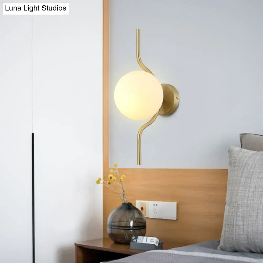 Decorbites gold brass globe wall sconce with white glass orb and curved arms on Tampa Home & Garden Store