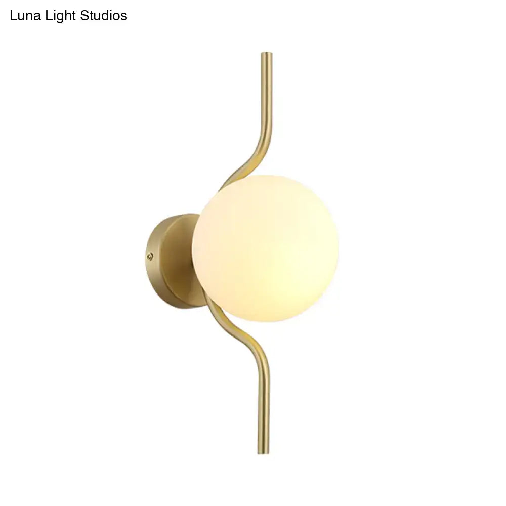Decorbites gold globe sconce with brass arm and glass orb on Tampa Home & Garden Store