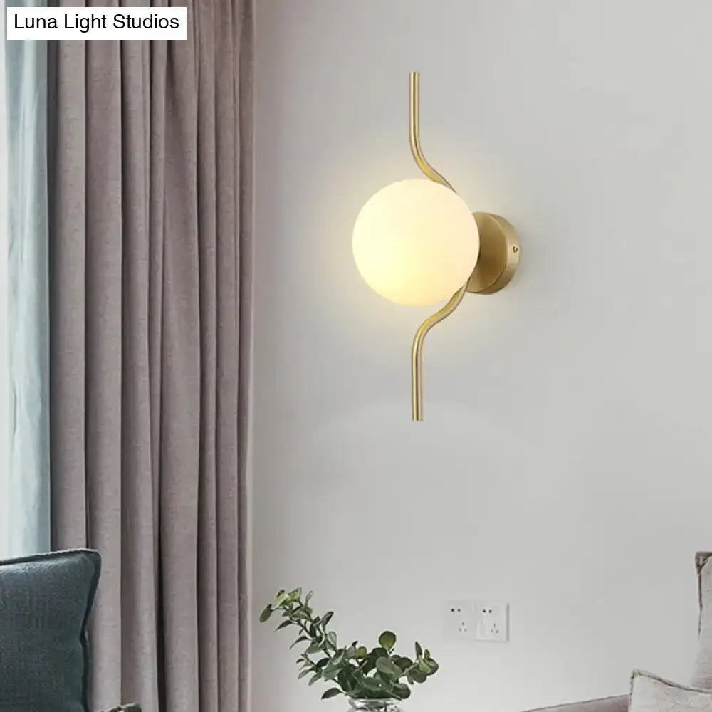 Decorbites Gold White Globe Sconce with glass globe and curved brass arms on Tampa Home & Garden Store