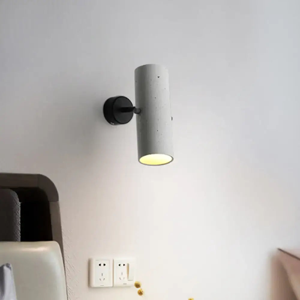Gray cement wall spotlight with black round mount casting downward light on bedroom wall on Tampa Home & Garden Store