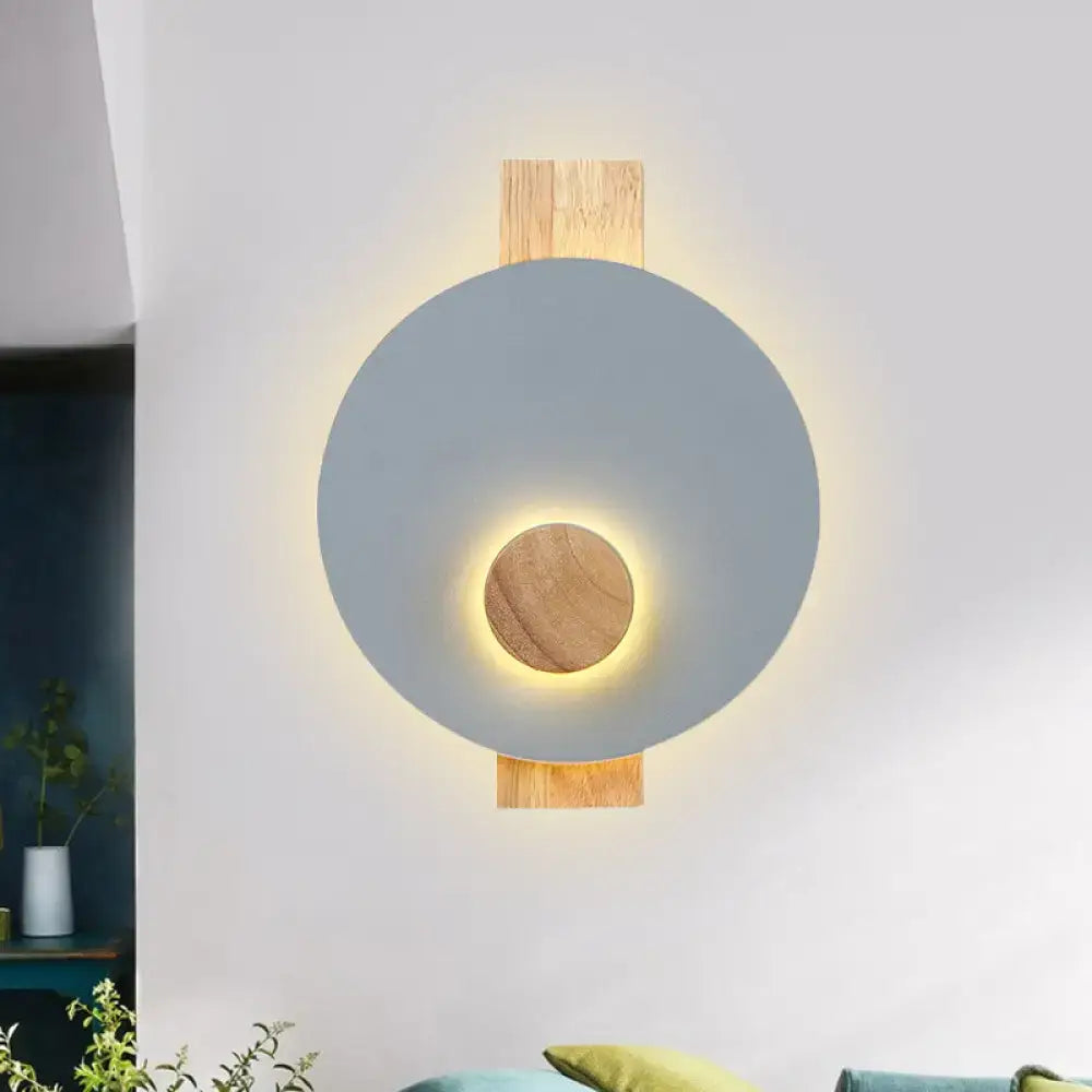 Gray metal disk sconce with wood mounting and warm backlit glow Decorbites on Tampa Home & Garden Store
