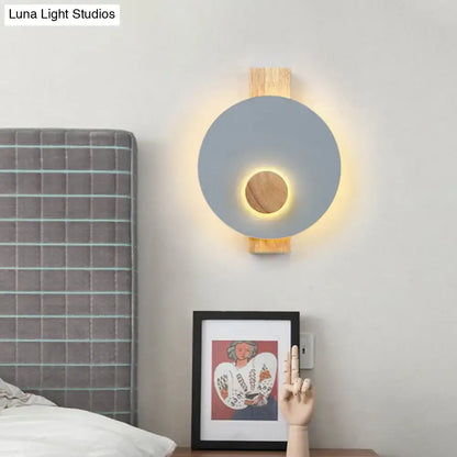 Gray metal disk sconce with wood mounting, warm halo lighting, Decorbites home wall light on Tampa Home & Garden Store