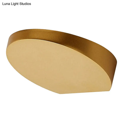 Grey aluminum minimalist corridor sconce with a gold-toned circular backplate on Tampa Home & Garden Store