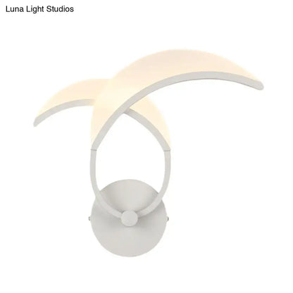 White curved wall sconce with circular base and arching arms by Decorbites on Tampa Home & Garden Store