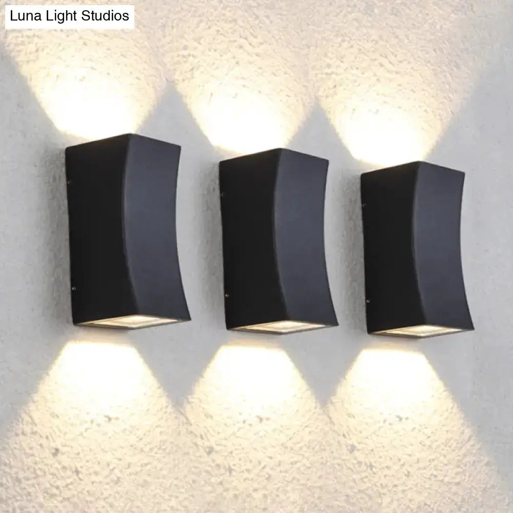 Minimalist black curved metal wall sconce 3-pack with warm uplight and downlight on Tampa Home & Garden Store