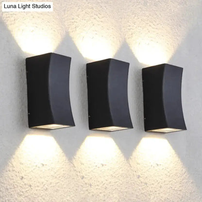 Minimalist black curved metal wall sconce 3-pack with warm uplight and downlight on Tampa Home & Garden Store