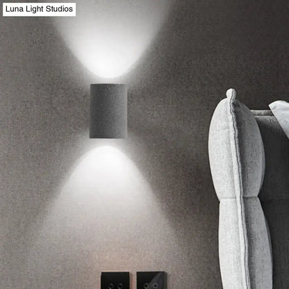 Speckled concrete wall light Decorbites cylindrical sconce with up and down glow on gray wall on Tampa Home & Garden Store