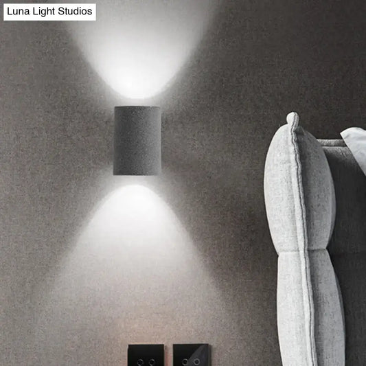 Speckled concrete wall light Decorbites cylindrical sconce with up and down glow on gray wall on Tampa Home & Garden Store