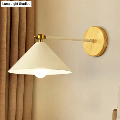 Minimalist white and brass pyramid wall sconce with conical shade on a wood round backplate on Tampa Home & Garden Store