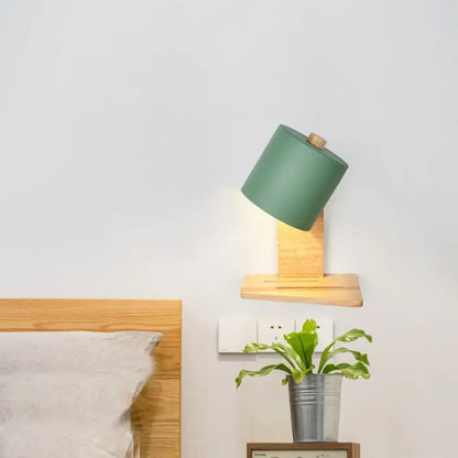 Green Nordic wall sconce with angled green shade and wooden mount on Tampa Home & Garden Store
