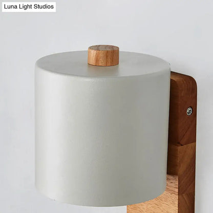 Green Nordic wall sconce with gray-green cylindrical shade and natural wood mount on Tampa Home & Garden Store