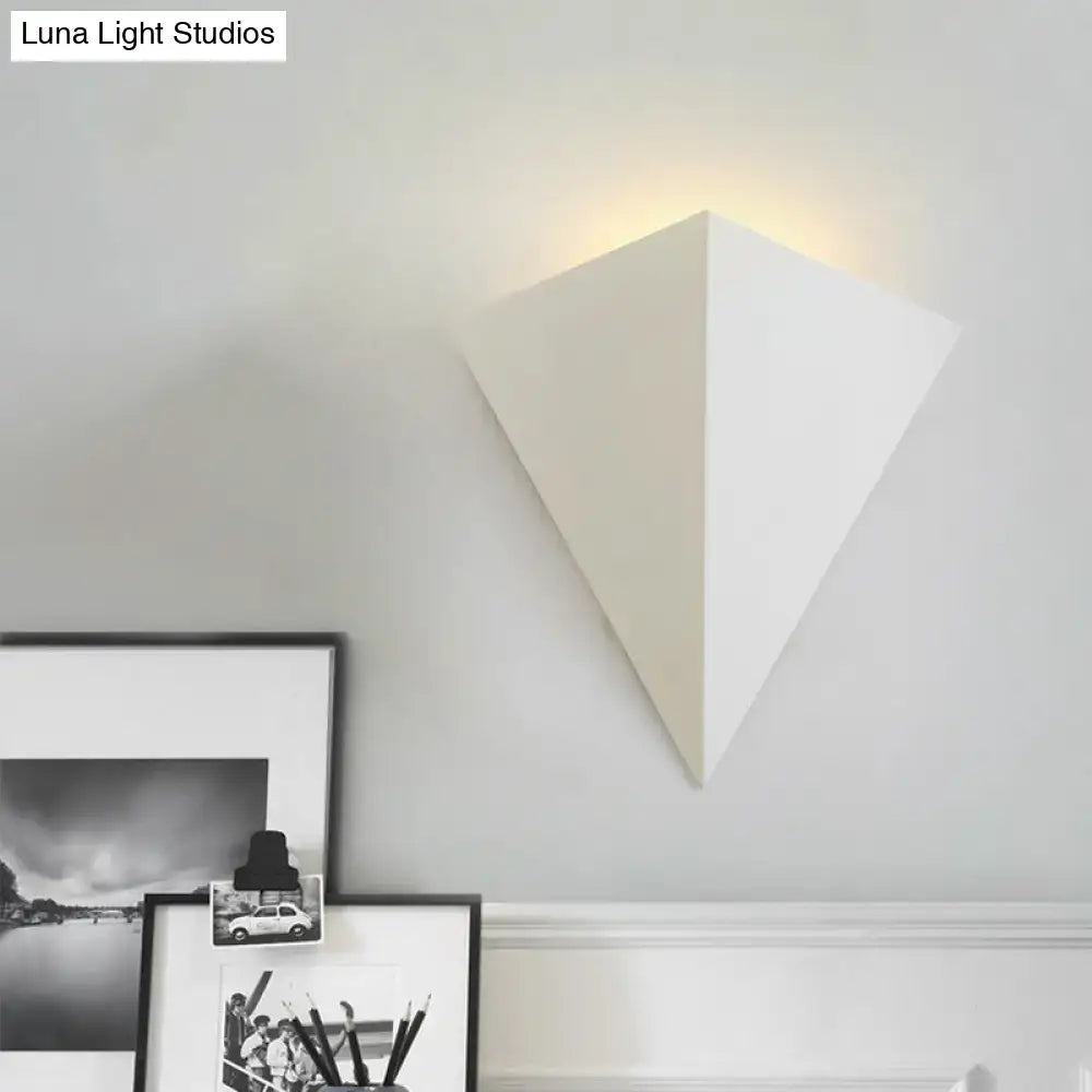 White cone wall lamp by Decorbites with a pyramid shade, wall mounted, emits warm glow on Tampa Home & Garden Store