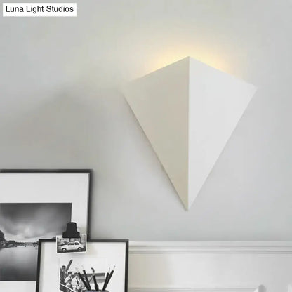 White cone wall lamp by Decorbites with a pyramid shade, wall mounted, emits warm glow on Tampa Home & Garden Store