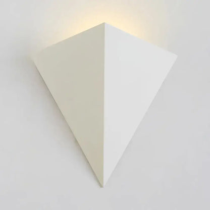 White cone wall lamp, minimalist geometric wall sconce in matte white casting warm light on Tampa Home & Garden Store