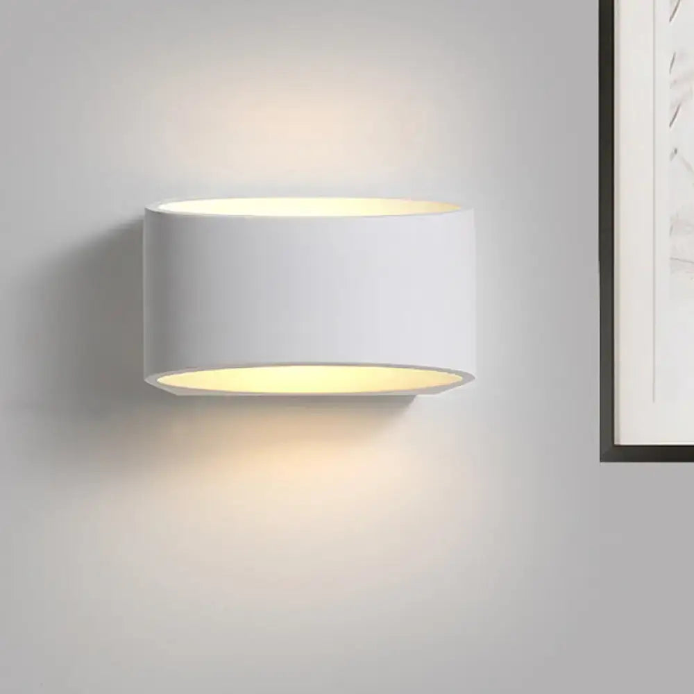 White cylindrical gypsum wall sconce with warm upward and downward light Decorbites on Tampa Home & Garden Store