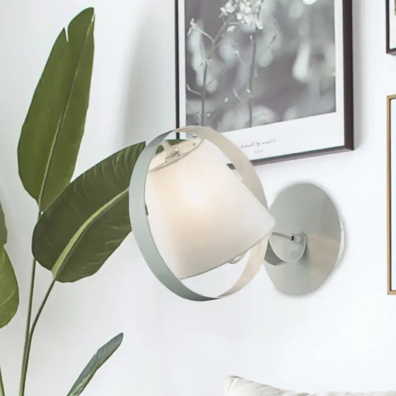 White fabric wall sconce with circular silver ring and frosted shade by Decorbites on Tampa Home & Garden Store