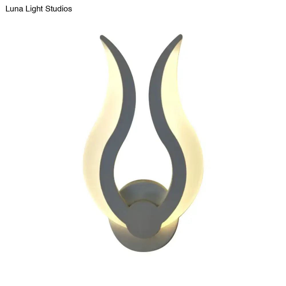 White acrylic flame sconce wall-mounted with warm glow on Tampa Home & Garden Store