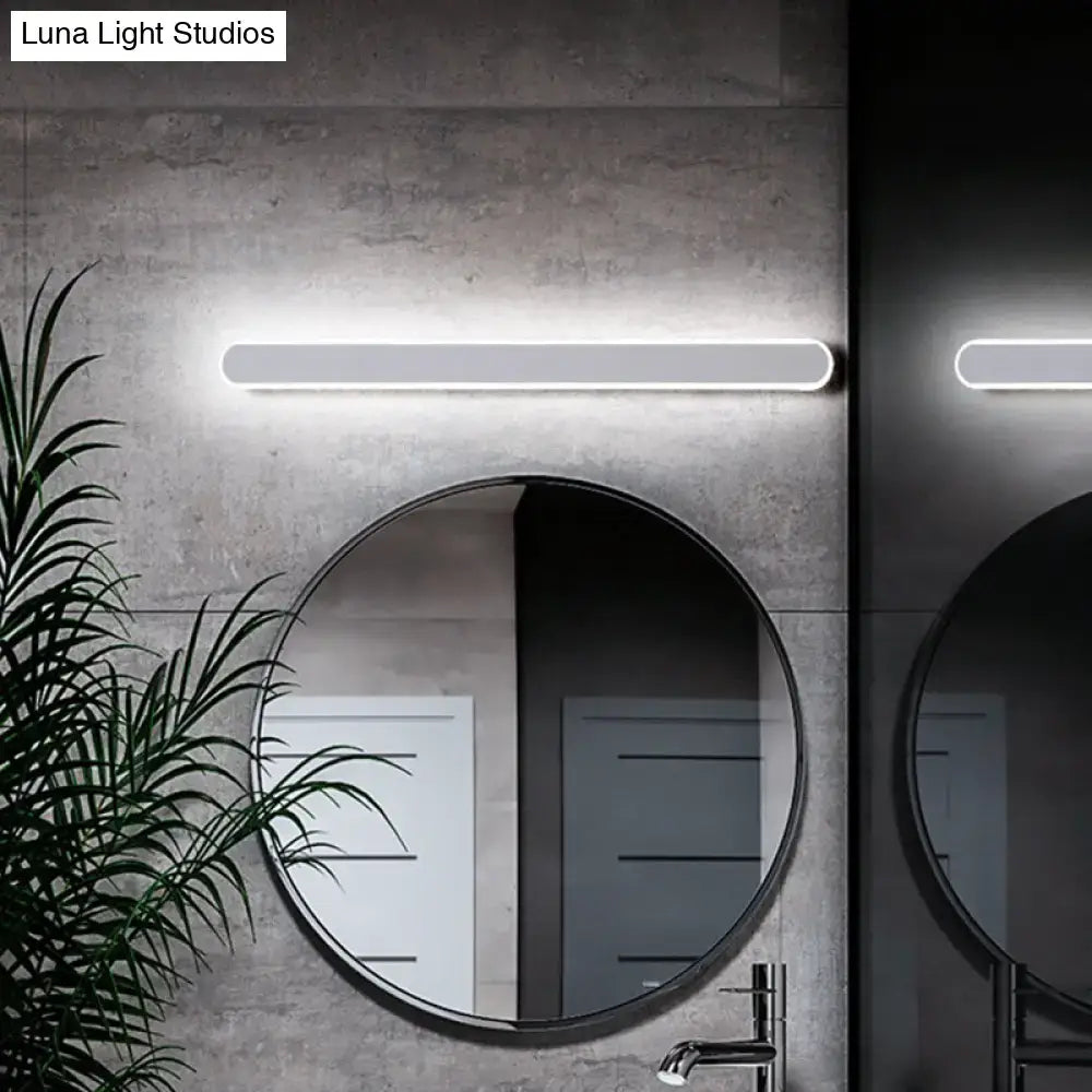Decorbites white LED acrylic vanity sconce with a rounded bar light above a circular mirror on Tampa Home & Garden Store