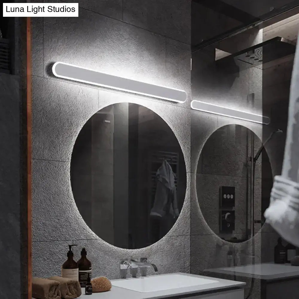 Pair of white LED acrylic vanity sconces with horizontal bar design above round bathroom mirrors on wall on Tampa Home & Garden Store