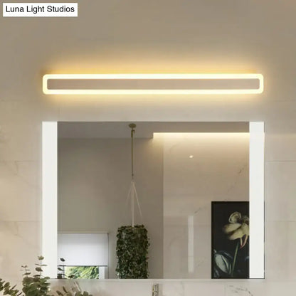 Minimalist white LED vanity light, slim rectangular ring above bathroom mirror with warm glow on Tampa Home & Garden Store