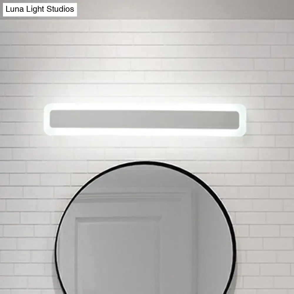 Minimalist white LED vanity light wall sconce above a circular mirror Decorbites on Tampa Home & Garden Store