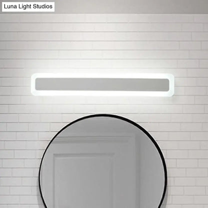 Minimalist white LED vanity light wall sconce above a circular mirror Decorbites on Tampa Home & Garden Store