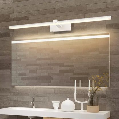 Minimalist white LED wall mount vanity light by Decorbites above a large bathroom mirror over gray tile wall on Tampa Home & Garden Store