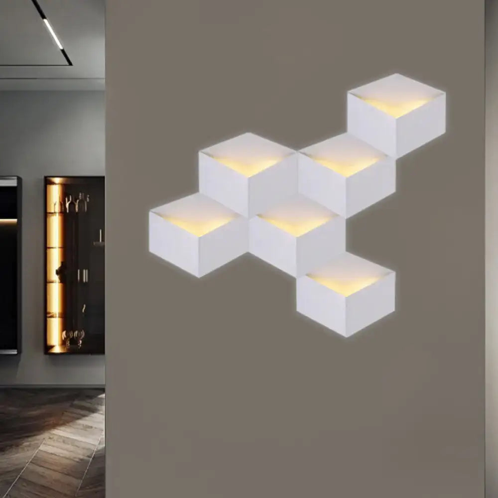 Decorbites white geometric wall light with six cubic modules emitting warm yellow glow on wall on Tampa Home & Garden Store