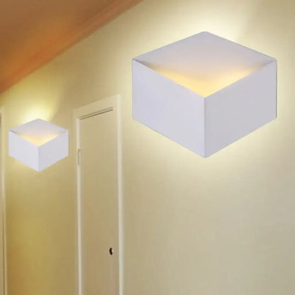 White geometric wall light cubes, pair with warm ambient glow along hallway on Tampa Home & Garden Store