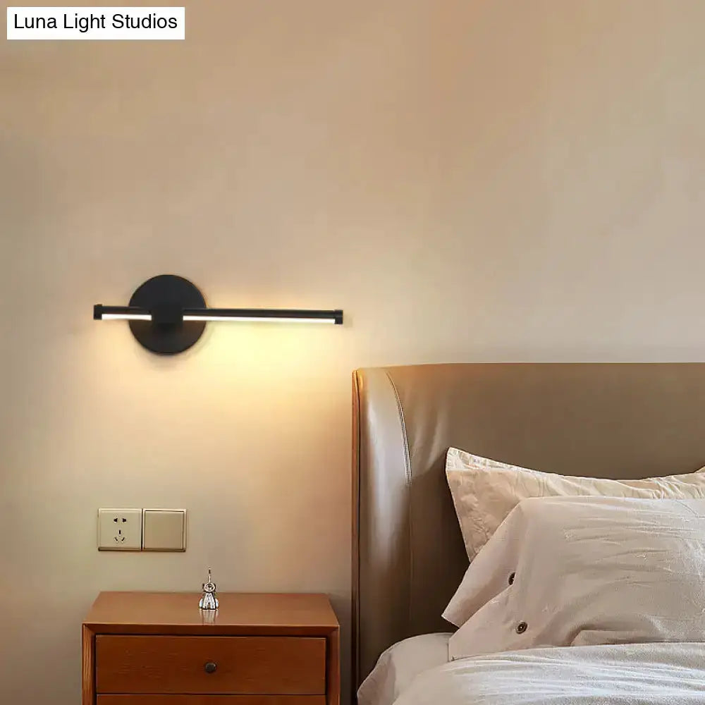 Minimalist white metallic LED wall sconce with round backplate and slim bar for bedroom on Tampa Home & Garden Store