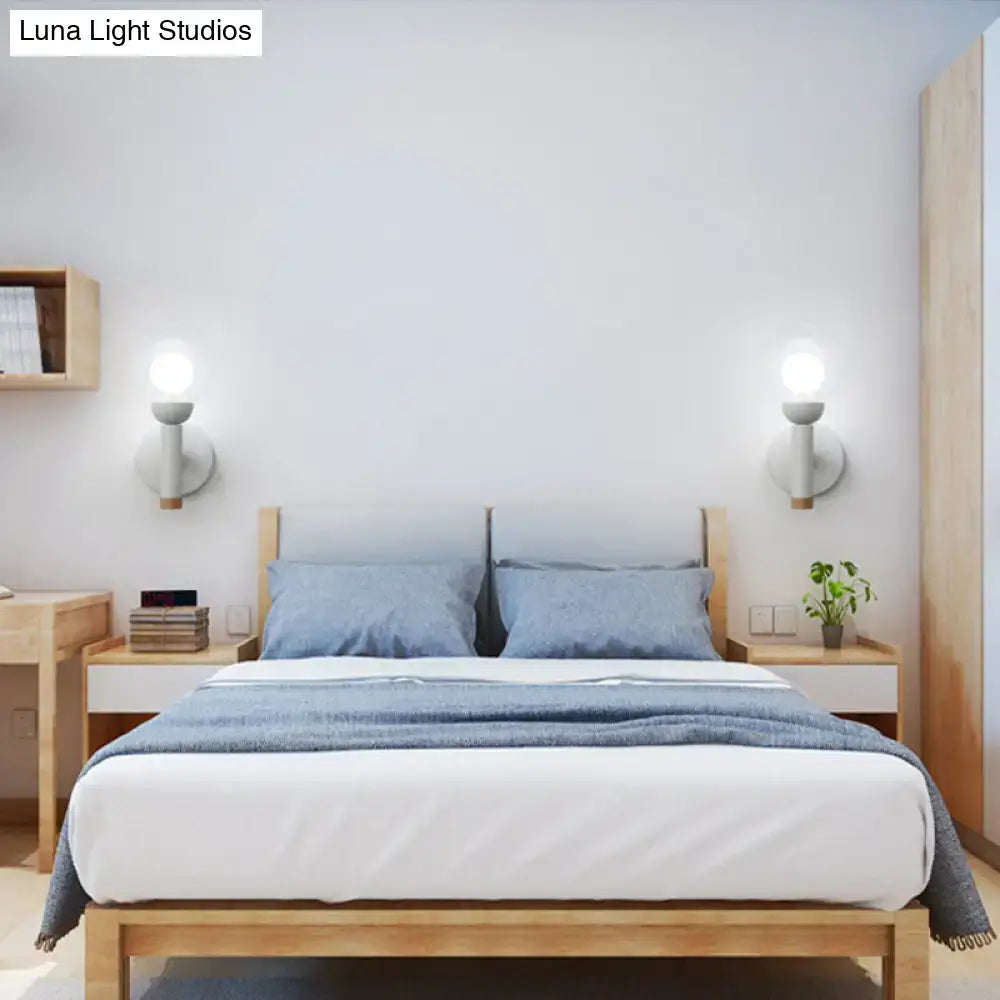 Two white wood armed lamps flank a wooden bed with blue bedding and nightstands on Tampa Home & Garden Store