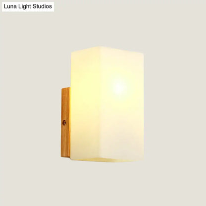 Opal glass wall sconce with wood backplate by Decorbites on Tampa Home & Garden Store