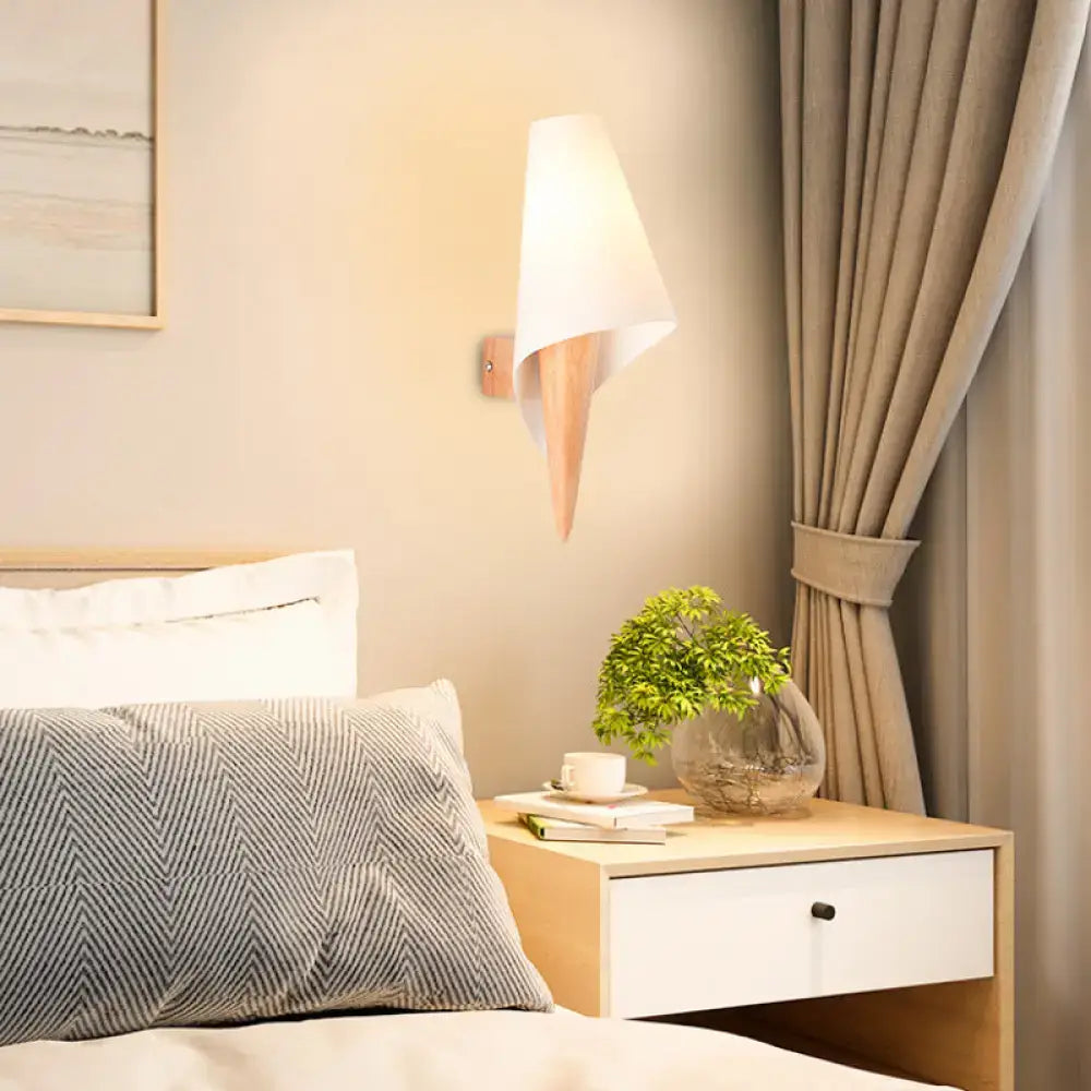 White glass wall light by Decorbites mounted above a bedside table with a plant, warm glow on Tampa Home & Garden Store