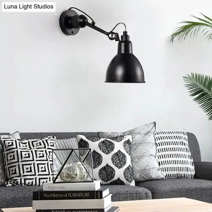 Black metal wall-mounted lamp with adjustable arm and dome shade in living room on Tampa Home & Garden Store