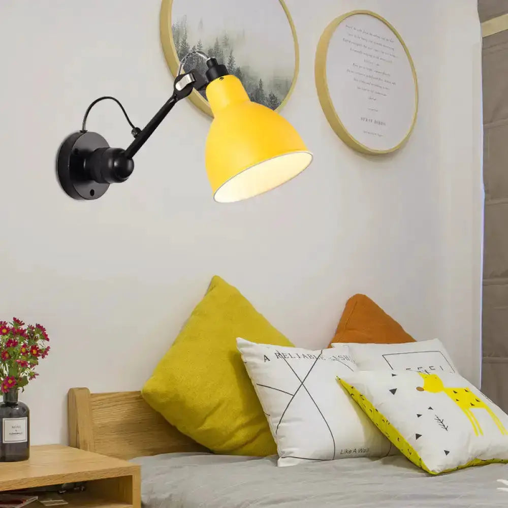 Wall-mounted lamp in yellow and black by Decorbites with adjustable arm over living room seating on Tampa Home & Garden Store