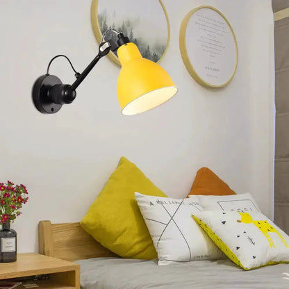 Wall-mounted lamp in yellow and black by Decorbites with adjustable arm over living room seating on Tampa Home & Garden Store