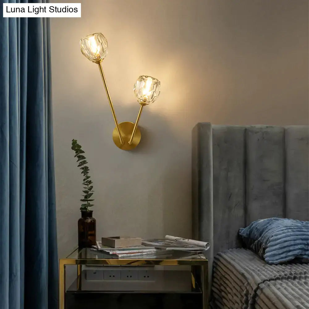 Brass branch glass sconce with two faceted glass shades, wall-mounted, warm glow by nightstand on Tampa Home & Garden Store
