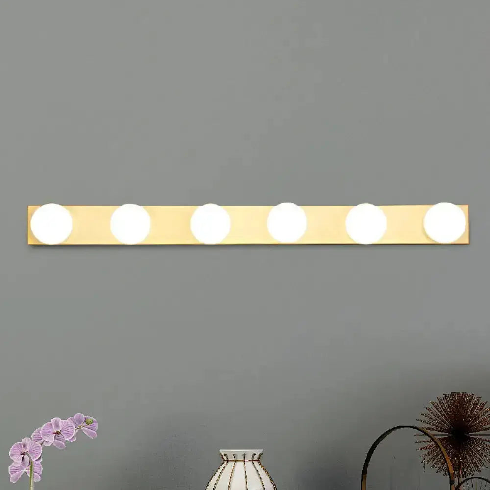 Minimalistic white 4-light vanity lighting fixture with open bulbs on brass bar Decorbites on Tampa Home & Garden Store
