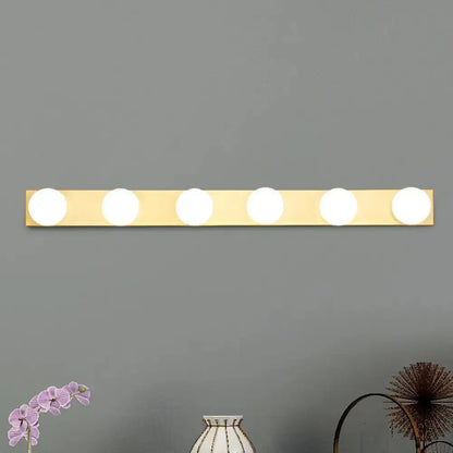 Minimalistic white 4-light vanity lighting fixture with open bulbs on brass bar Decorbites on Tampa Home & Garden Store