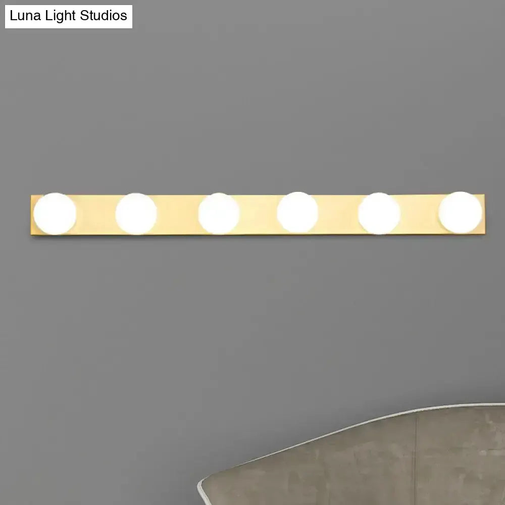 4-light bathroom vanity light fixture with white open bulbs on a gold bar on Tampa Home & Garden Store