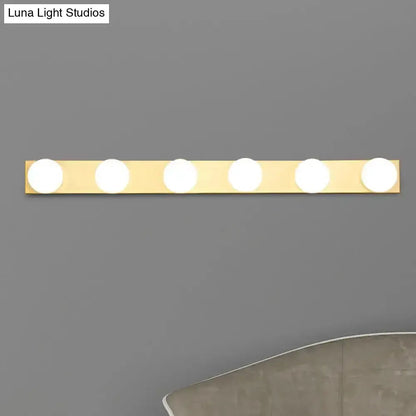 4-light bathroom vanity light fixture with white open bulbs on a gold bar on Tampa Home & Garden Store