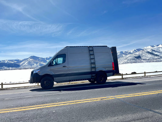 The Ultra Rack low-profile roof rack on a gray Sprinter van with ladder by avatar offroad on Tampa Home & Garden Store