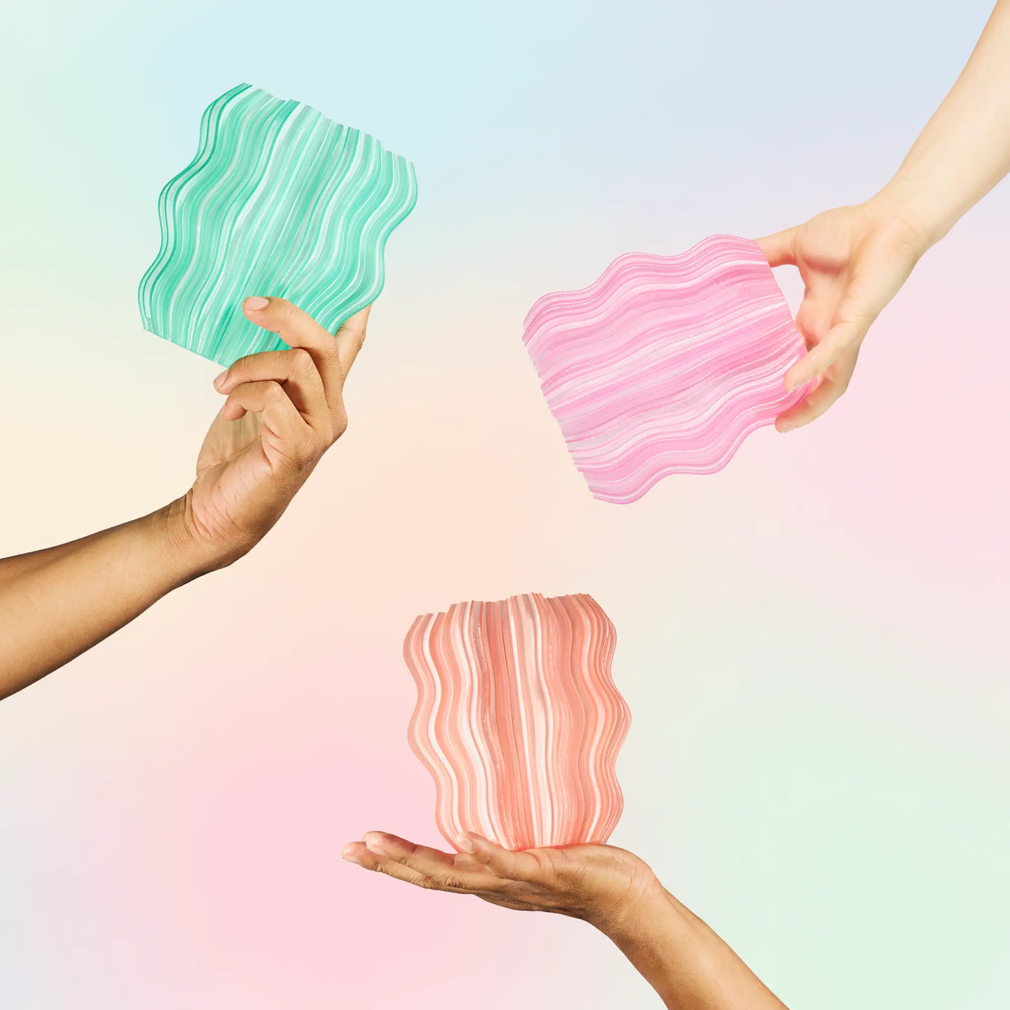 Mini Wavy Lamp for Ambient Atmosphere two turquoise and pink wavy pieces held by hands on Tampa Home & Garden Store