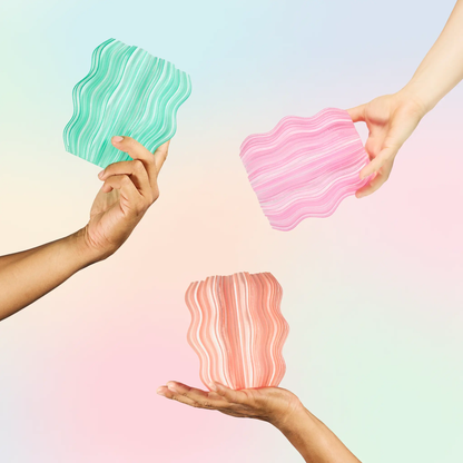 Mini Wavy Lamp for Ambient Atmosphere two turquoise and pink wavy pieces held by hands on Tampa Home & Garden Store